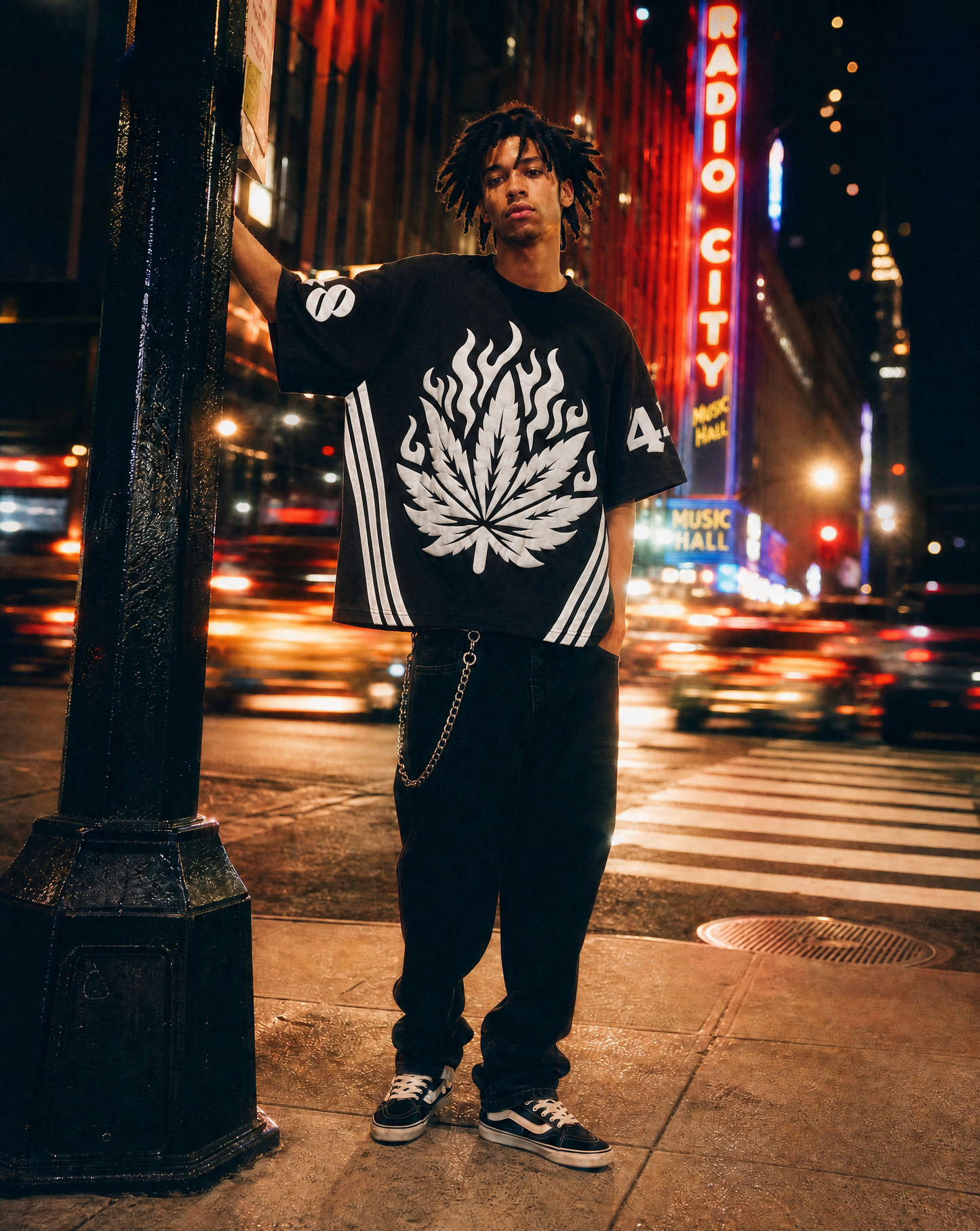 Model wearing Pushin Flowers Striped graphic shirt with white side stripes on a city street