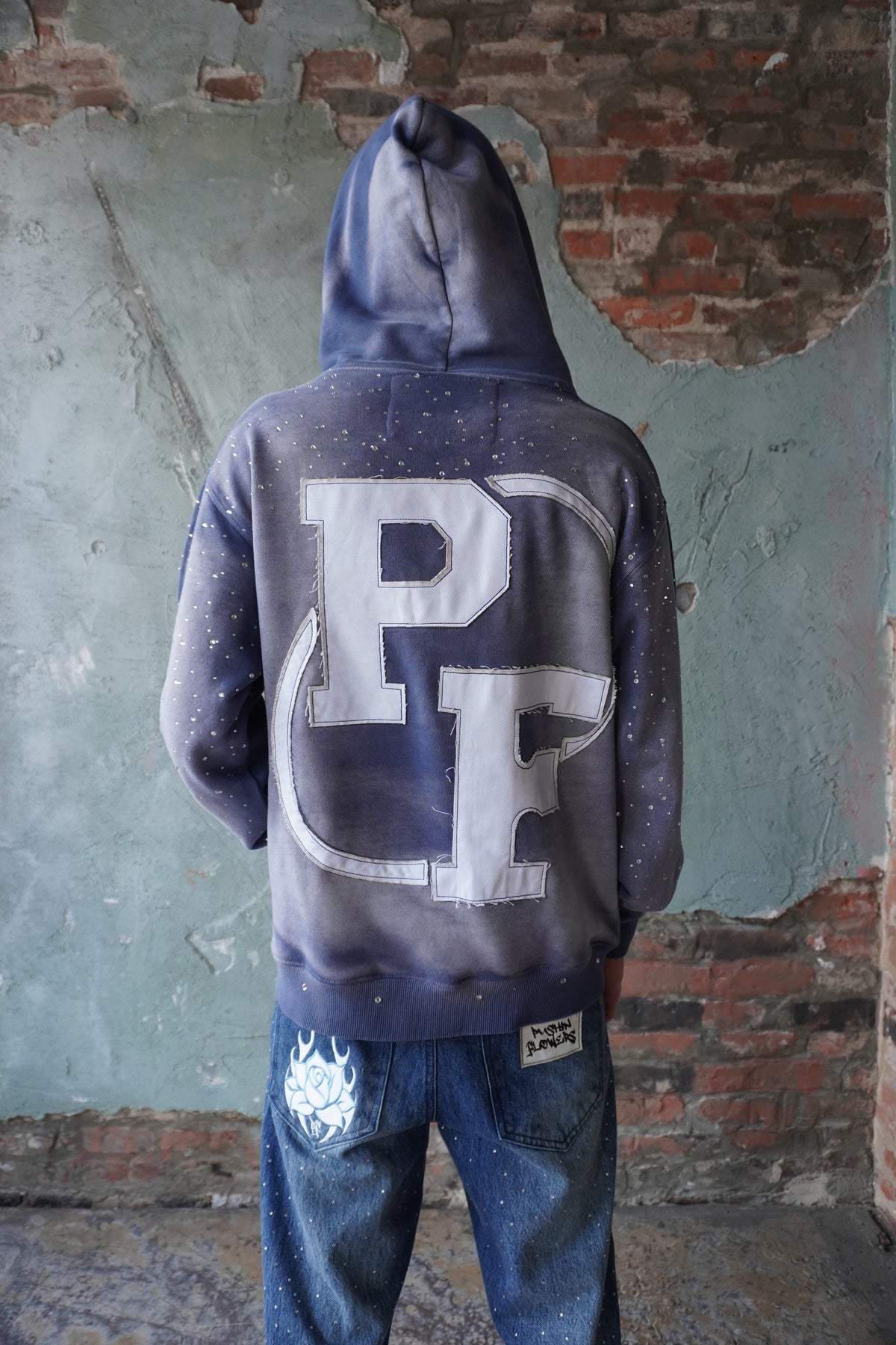Pushin Flowers rhinestone patch hoodie – premium streetwear pullover, close-up detail