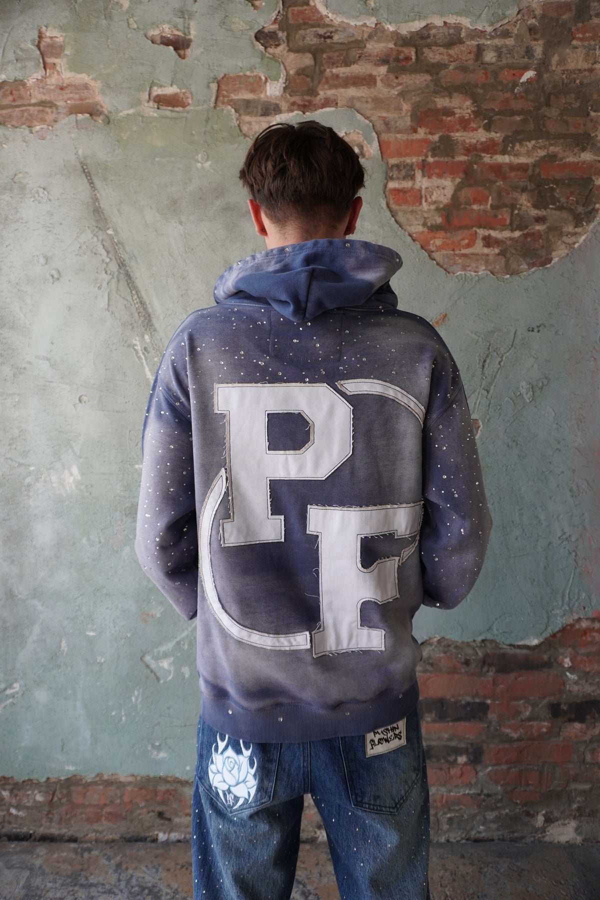 Pushin Flowers rhinestone patch hoodie – premium streetwear pullover, studio flat-lay