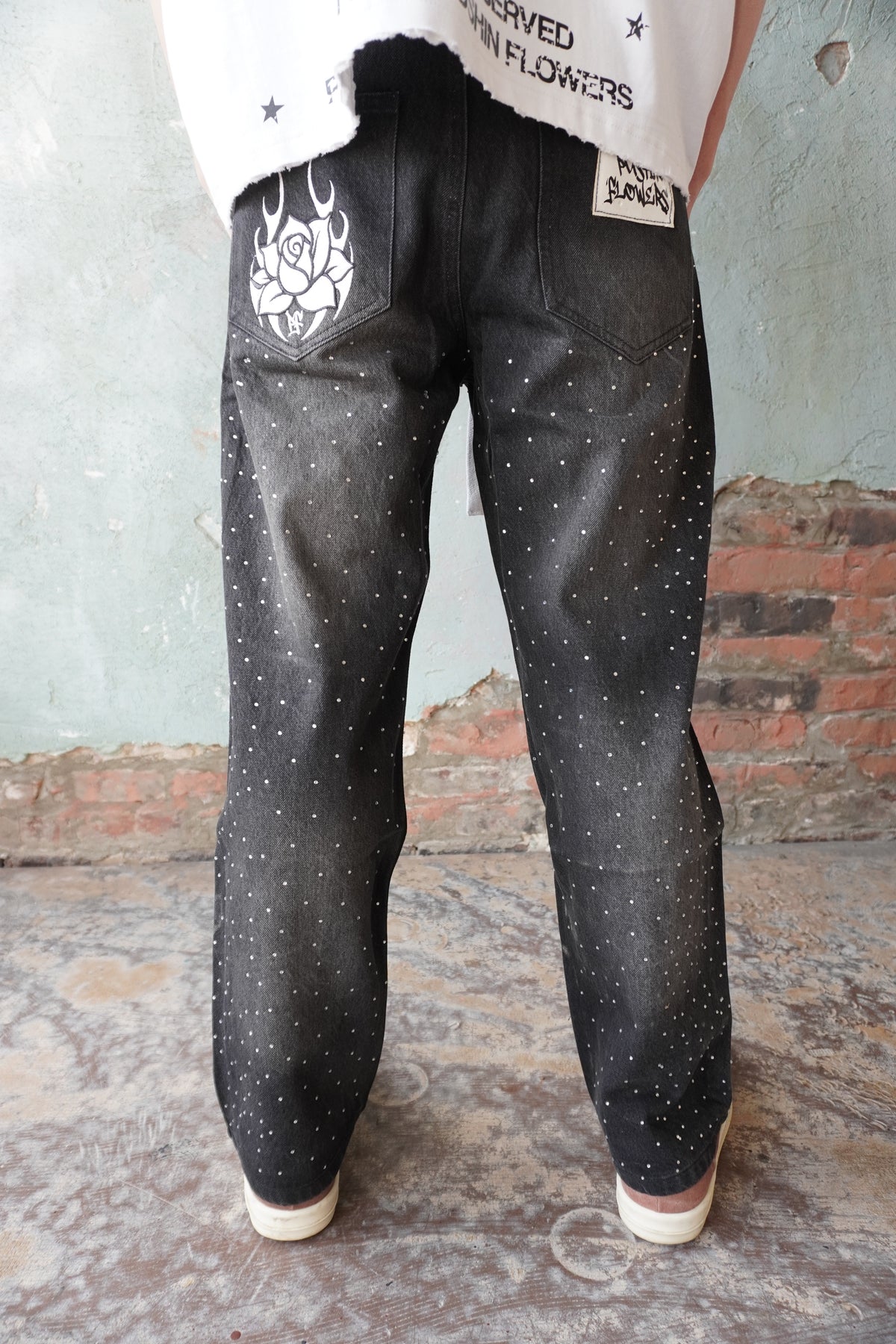 Pushin Flowers rhinestone patch denim jeans – PF statement streetwear, close-up detail