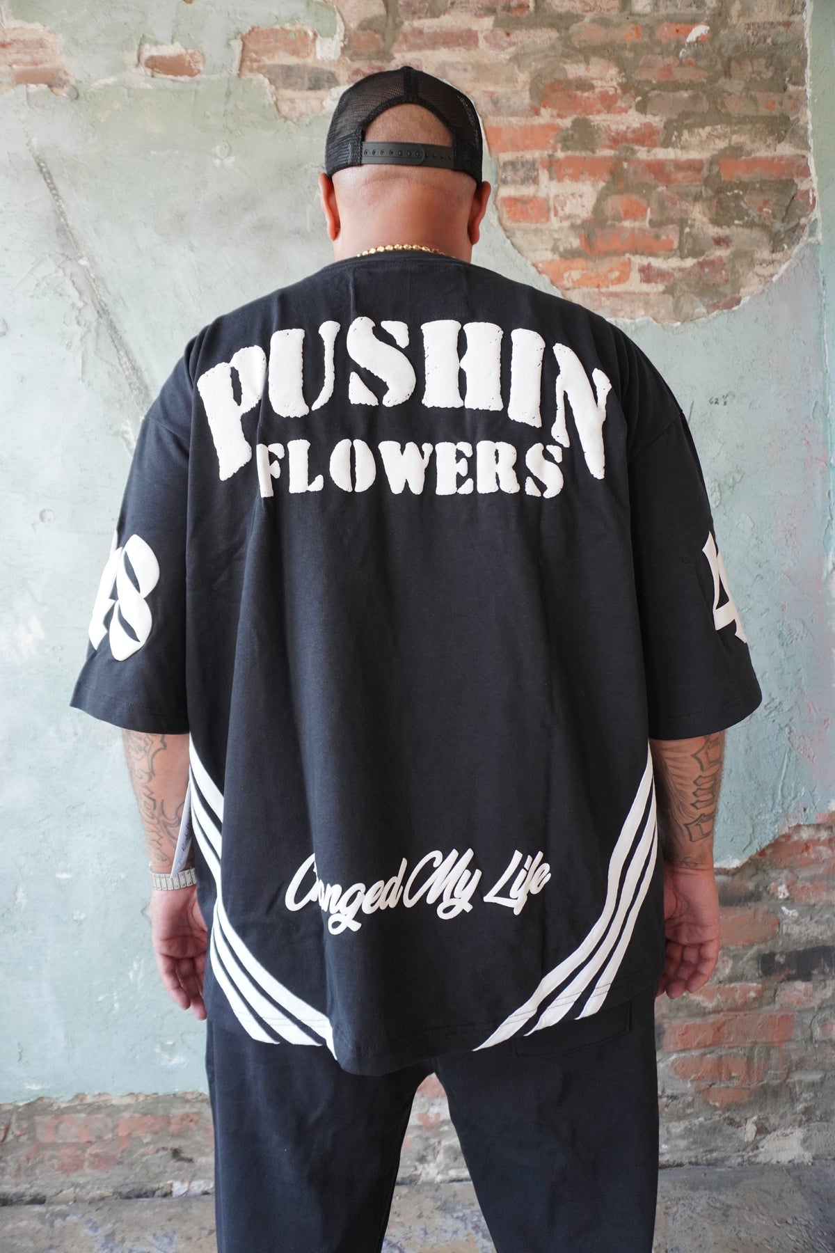 Pushin Flowers striped graphic shirt – PF bold streetwear, model wearing, full-length