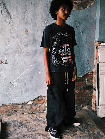 Full-length shot of model in the Acid Washed Black Crash Out tee, styled with sneakers