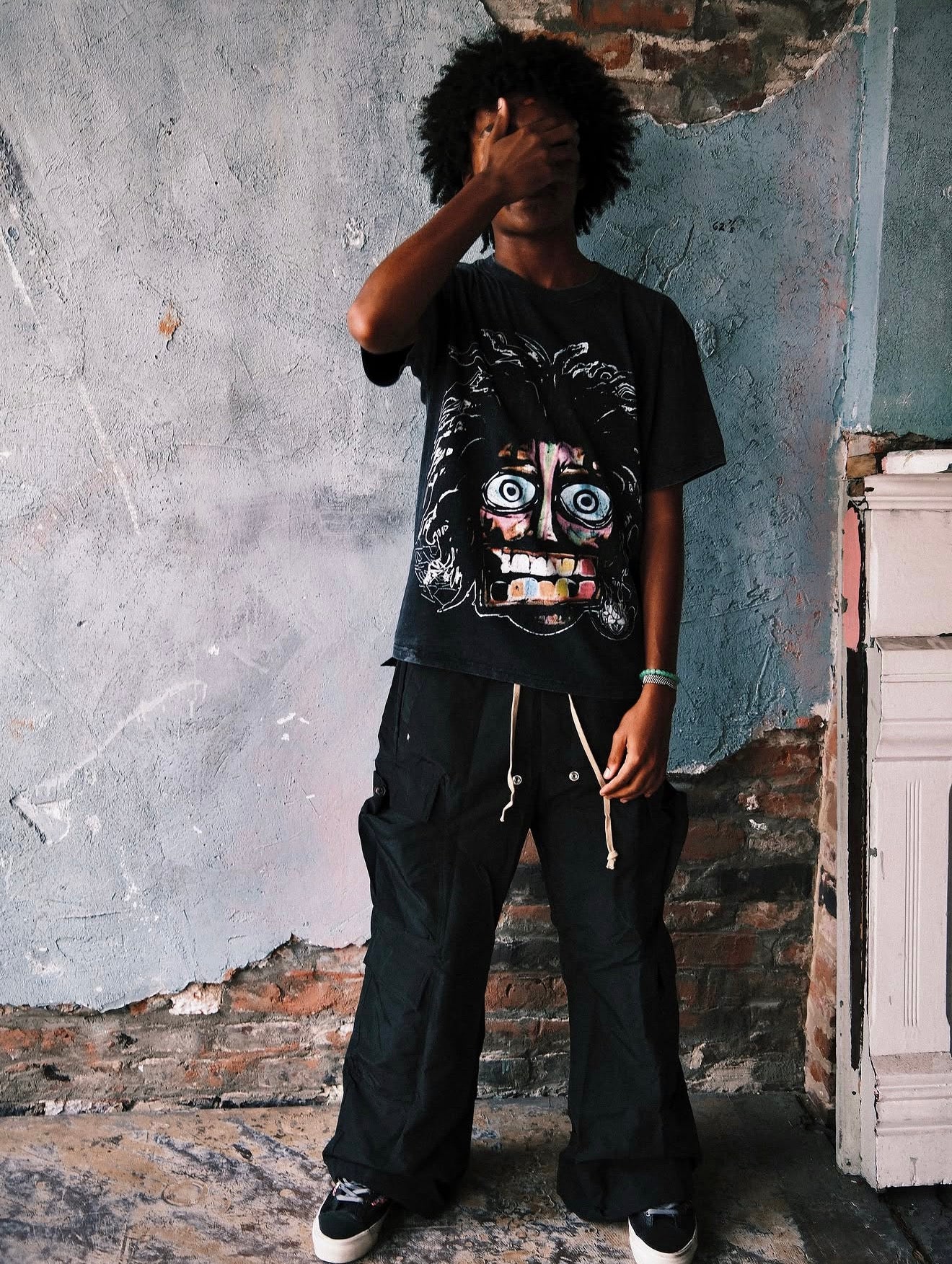 Model in the Acid Washed Black Crash Out tee, side stance, full outfit and footwear visible