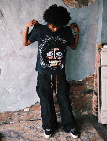 Model wearing the Acid Washed Black Crash Out tee, angled view showing the drop-shoulder oversized fit