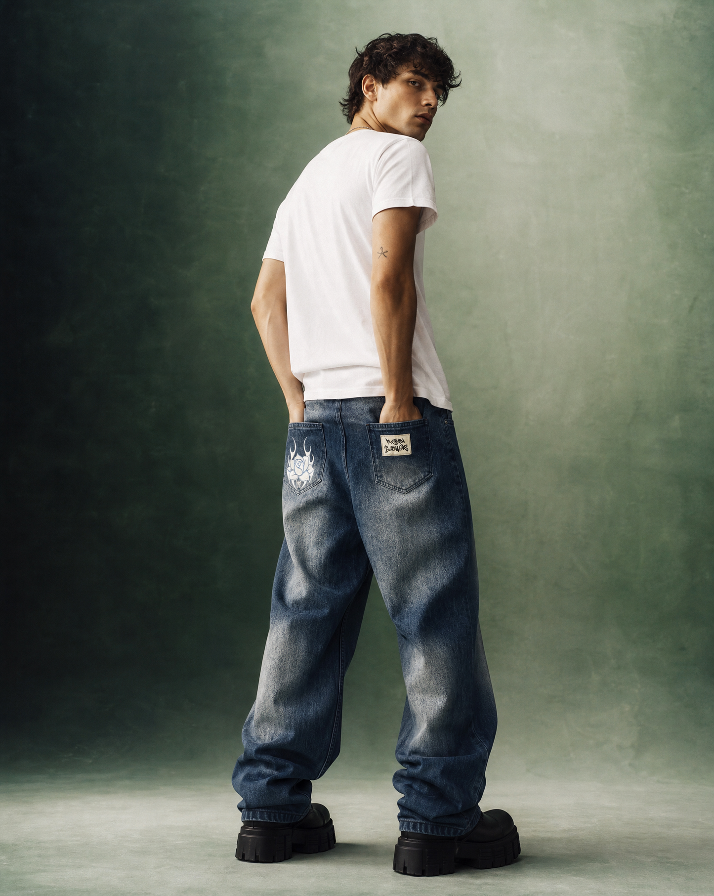 Model wearing Pushin Flowers Baggy Denim Jeans in black, streetwear editorial photo