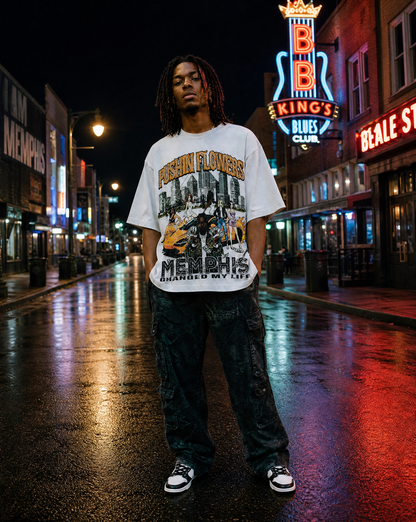 Model wearing Pushin Flowers Memphis graphic t-shirt on Beale Street in Memphis at night