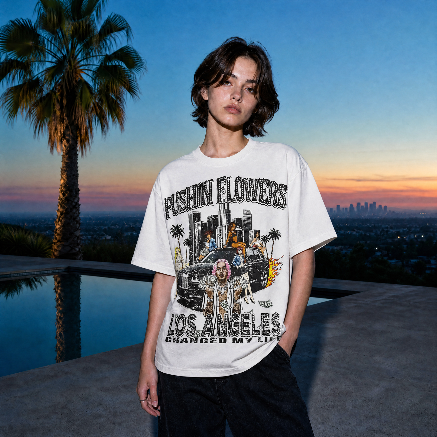 Model wearing Pushin Flowers Los Angeles graphic t-shirt at golden hour with the LA skyline
