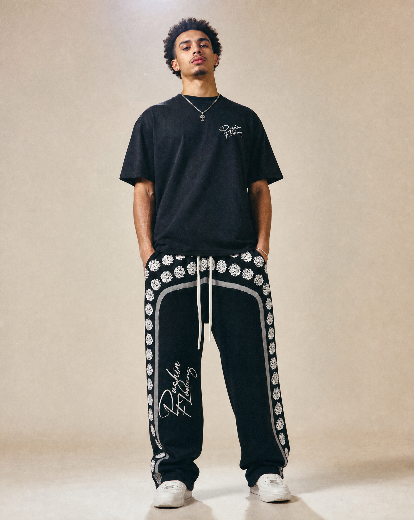 Model wearing Pushin Flowers Leaf Print baggy pants, streetwear photo