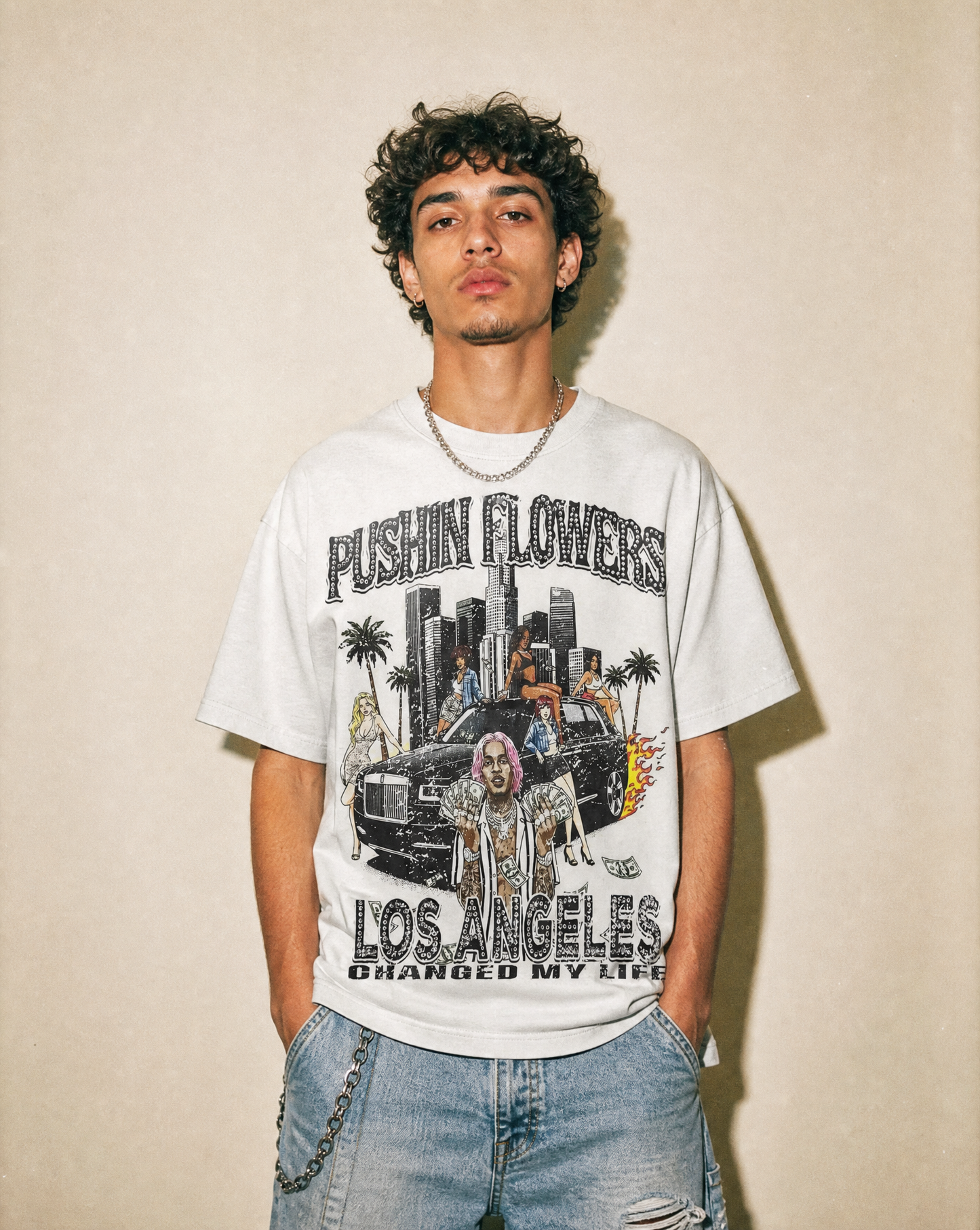 Model wearing Pushin Flowers Los Angeles graphic t-shirt, studio streetwear photo