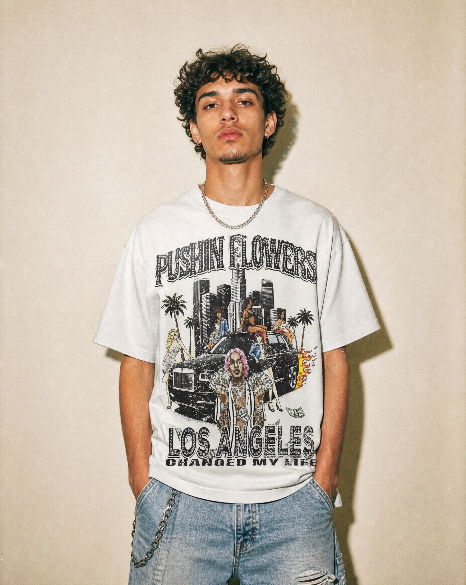 Model wearing Pushin Flowers Los Angeles graphic t-shirt, studio streetwear photo