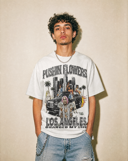 Model wearing Pushin Flowers Los Angeles graphic t-shirt, studio streetwear photo