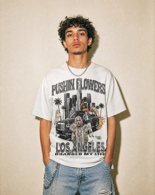 Model wearing Pushin Flowers Los Angeles graphic t-shirt, studio streetwear photo