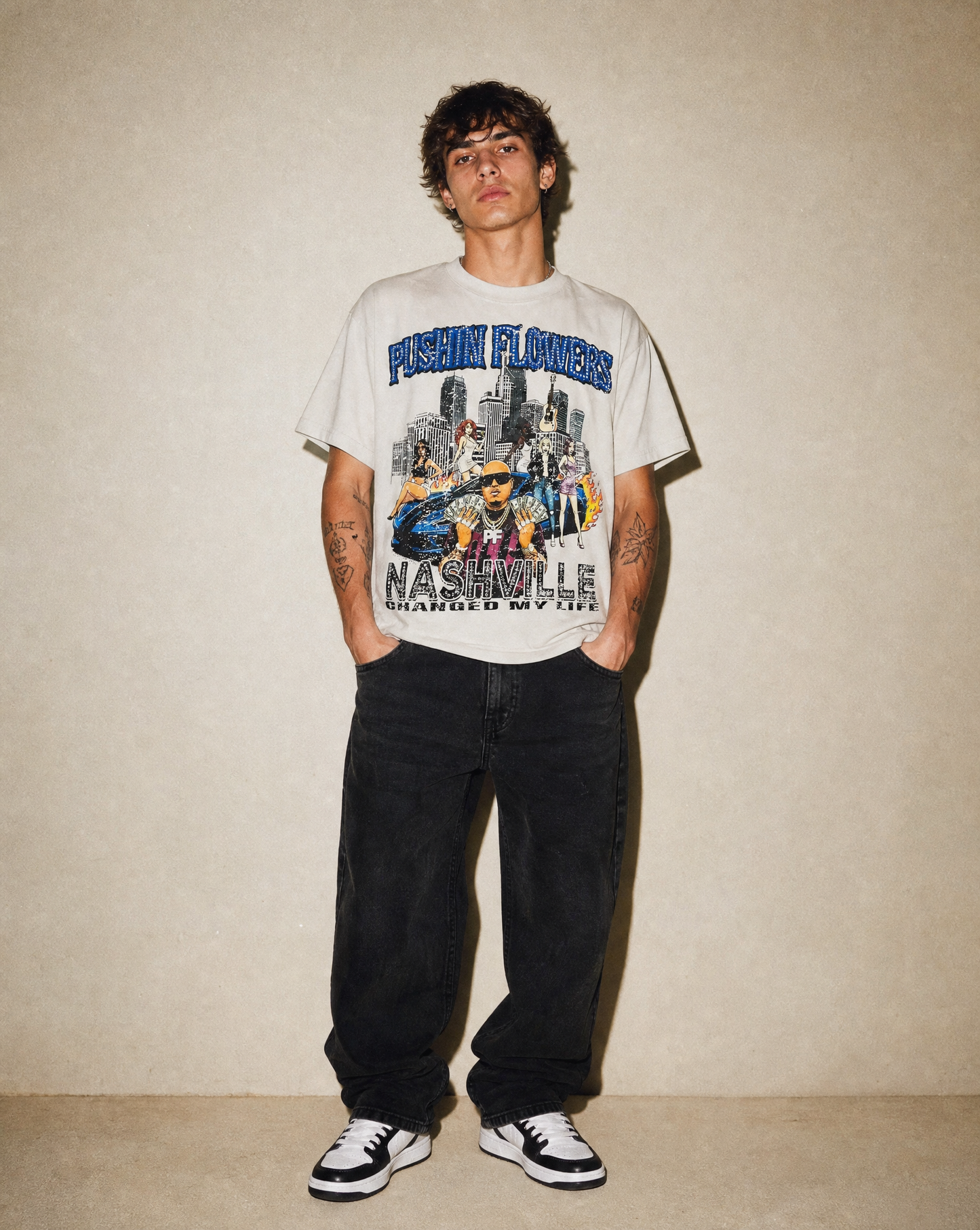 Model wearing Pushin Flowers Nashville graphic t-shirt, studio streetwear photo
