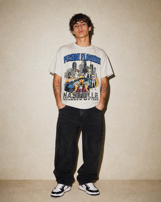 Model wearing Pushin Flowers Nashville graphic t-shirt, studio streetwear photo