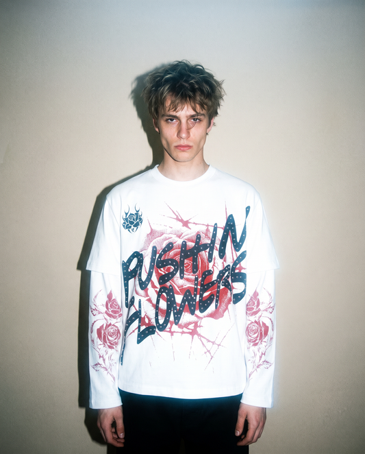 Model wearing Pushin Flowers Rose graphic long sleeve shirt, studio streetwear photo