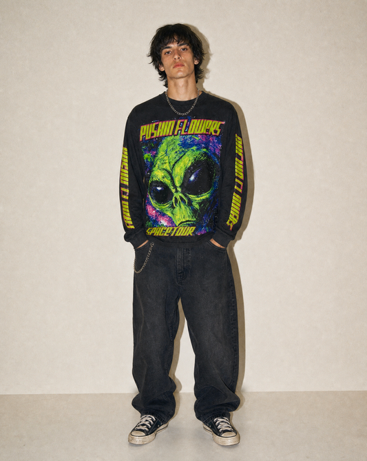 Model wearing Pushin Flowers Spacetour graphic long sleeve shirt, studio streetwear photo