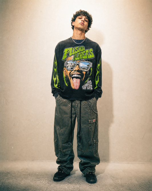 Model wearing Pushin Flowers "The Life" graphic long sleeve shirt in black, studio streetwear photo