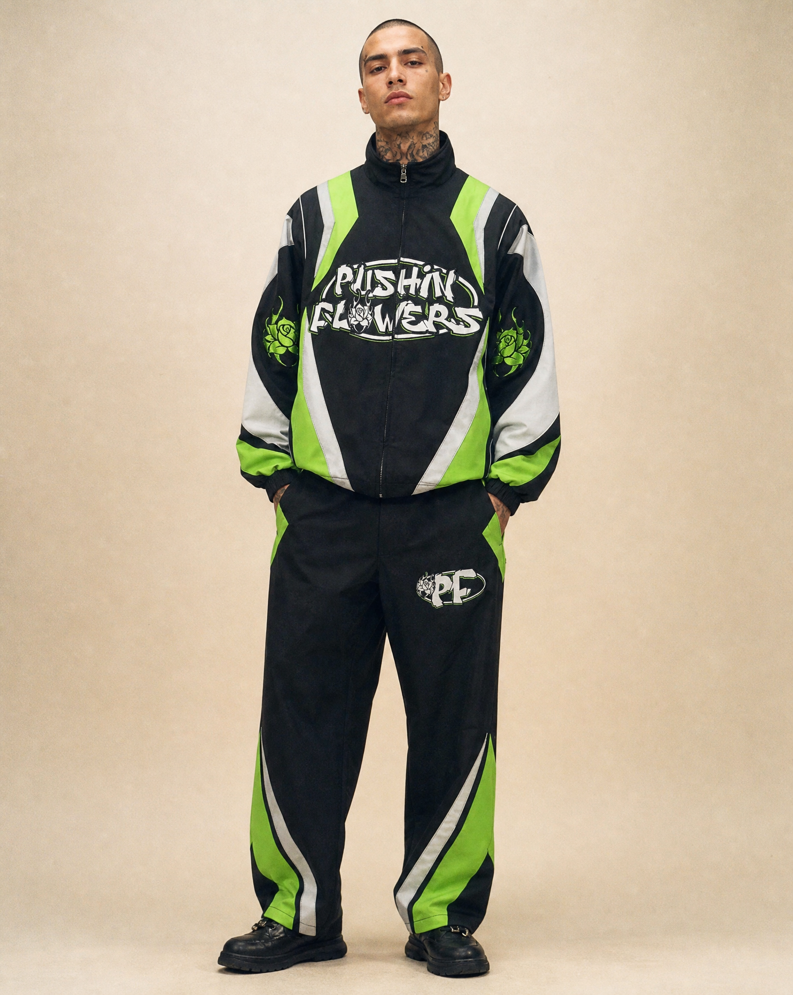 Model wearing Pushin Flowers Two-Piece Track Suit, studio streetwear photo